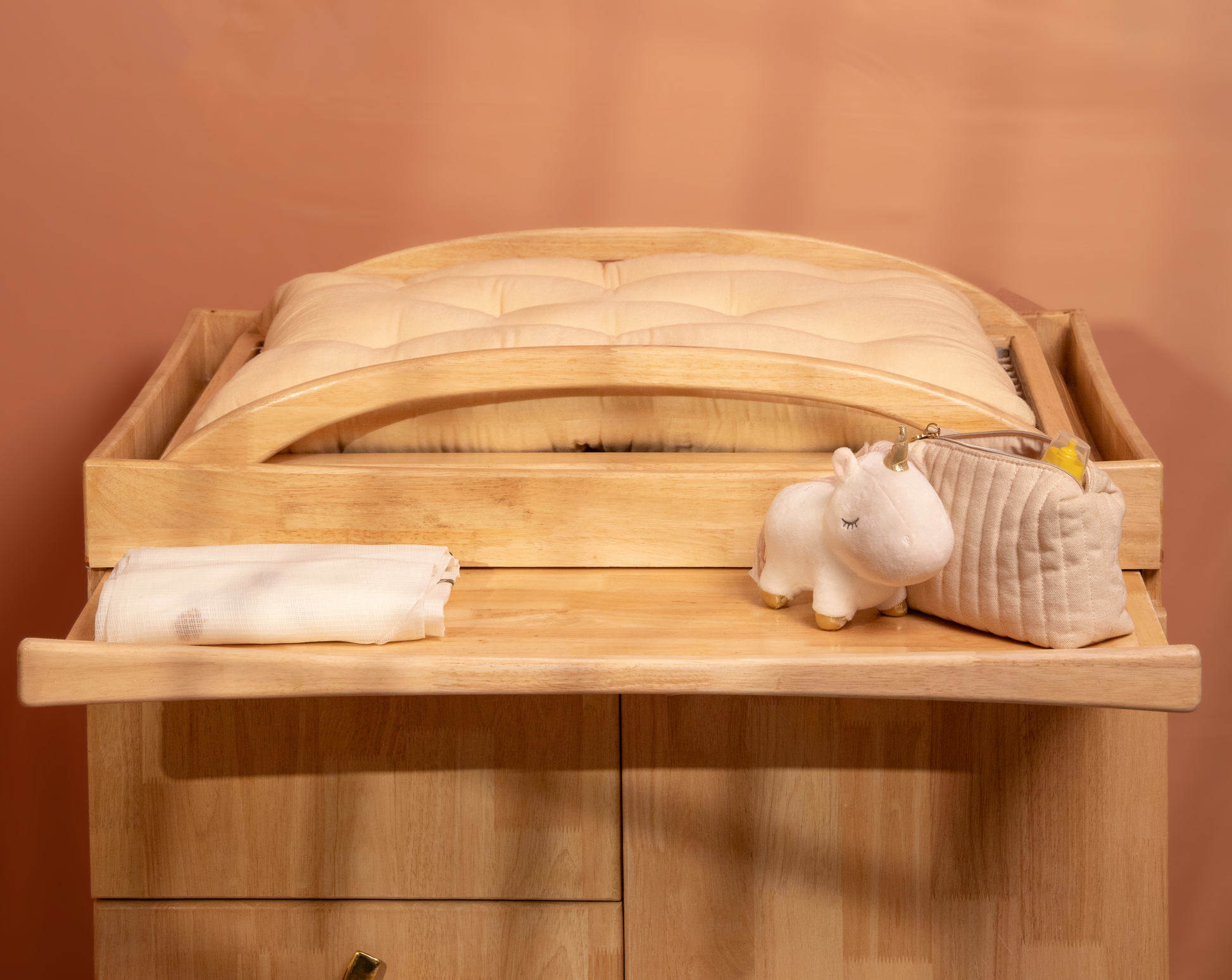 changing station on the cabinet with a pull out tray to place toiletries and extra stuff