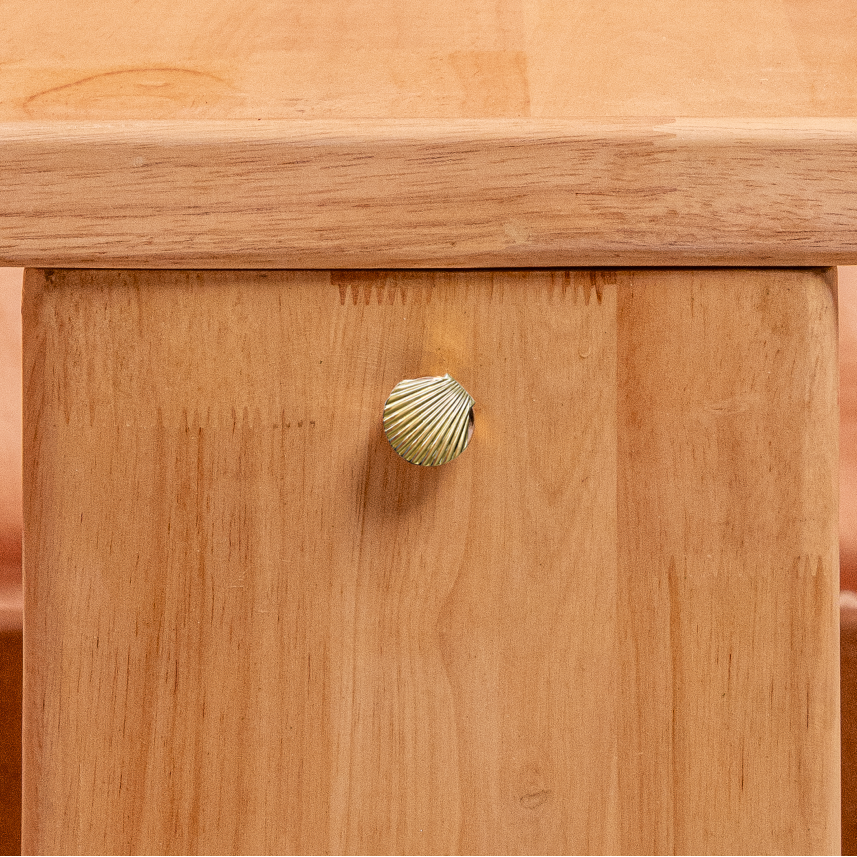 Wooden table with a unique shell base design on a textured surface