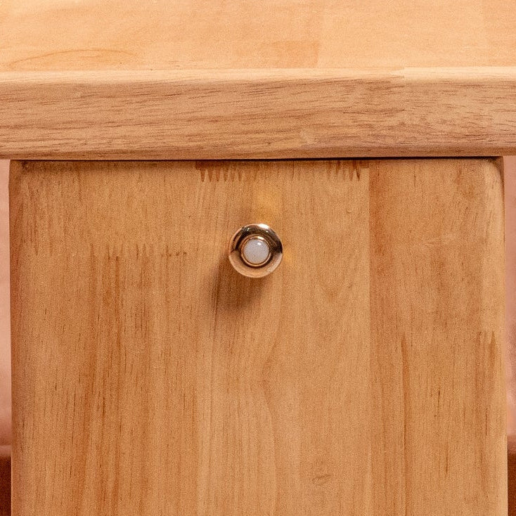 Wooden table with chairs and cushions against a plain background
